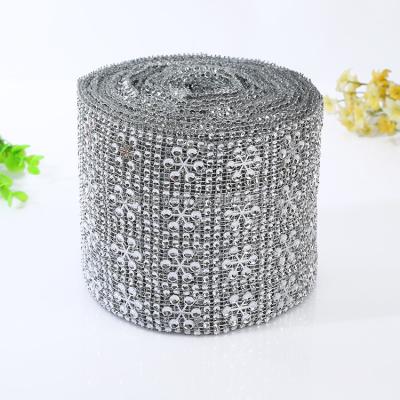 China Wholesale 16 Rows Pyramid Diamante Rhinestone Plastic Mesh Ribbon Bag Manufacturers For Wedding Table Wrap for sale