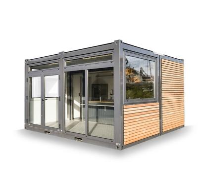 China 20ft Container Store Wood Grain Metal Frame Hotel Mobile House with Galvanized Steel Square Tubes and Flat Packaging for sale