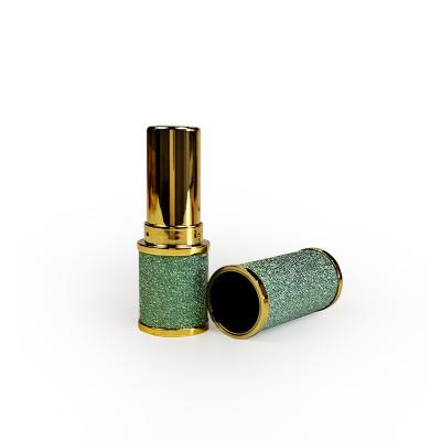 China Ryinestone bling Shimmery cosmetic round lipstick tubes with gold belt for sale