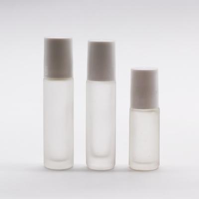 China Custom 10ml Personal Care Frosted White Color Glass Roller Bottles With Wooden Caps for sale