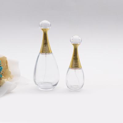 China 30ml 100ml round shape cosmetic custom special transparent glass perfume bottle with gold top cap for sale