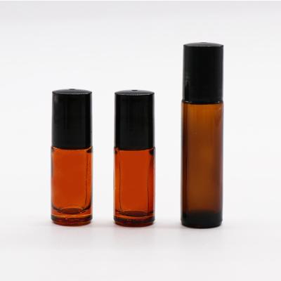 China Custom Cosmetic Personal Care Amber Oil 10ml Rollball Bottle With Black Plastic Lids for sale