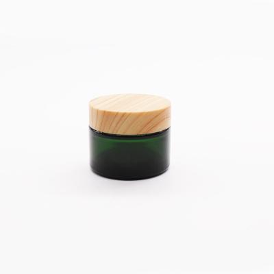 China Wholesale Cosmetic Luxury Green 50g Cream Glass Jar With Bamboo Lids for sale