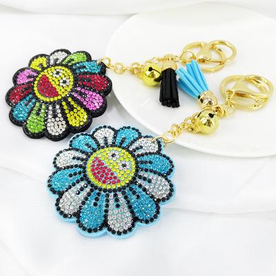 China Cute Classic Cartoon Sunflower Smiley Korean Velvet Diamond Keychain Sun Flower Bag Tassel Pendant Charm for sale