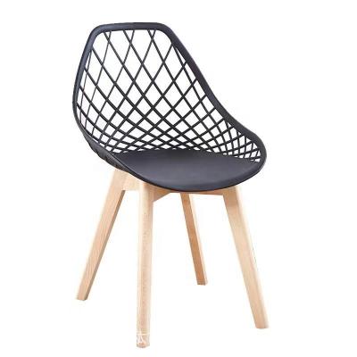 China Scandinavian Modern Outdoor Chair Plastic Hollow Chair With Wooden Legs Home Dining Party Chair PP for sale