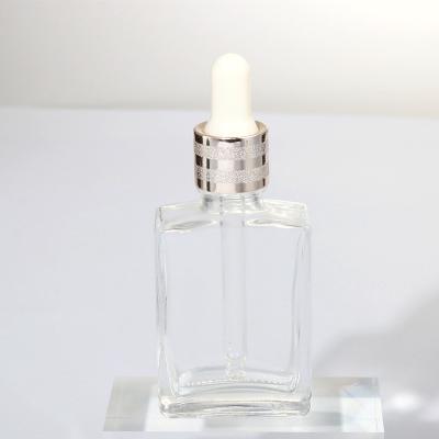 China Cosmetic Glass Bottle High End Rectangular Screw Cap Essential Oil Pump Bottles Flat Dropper 50ml Bottle for sale