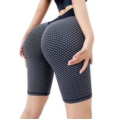 China Yoga Hip Peach Honeycomb Buttocks Sports Tights Elastic Hip Lift Fitness Pants Breathable Seamless Five-Point Waist High Handsome Pants for sale