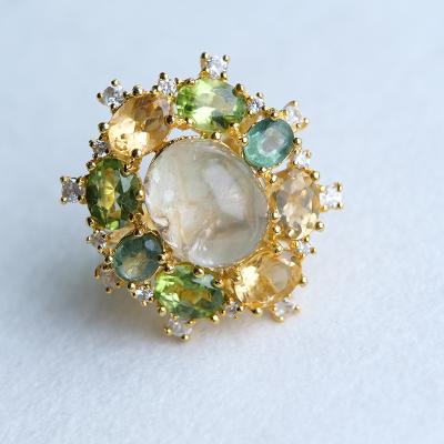 China Large CLASSIC Yellowish Green Hair Crystals Surrounded By Gorgeous Gold Inlaid Cubic Zirconia Forest Green Jewelry Woman Ring for sale