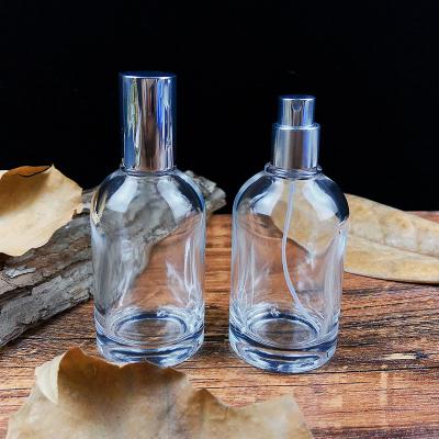 China Personal Care Custom Round Empty Clear Perfume Glass Perfume Bottle 50ml Perfume Spray Glass Bottles With Cap for sale