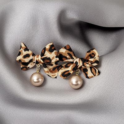 China Trendy Trendy Dark Pearl Bow Flannel Print Leopard Classic Earrings for sale