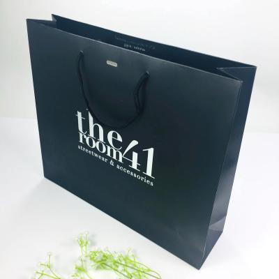 China Clothing Shoes Gift Packaging China Supplier Customized Flat Bottom Black Bag Waterproof Shopping Kraft Paper Bag With Silver Logo for sale