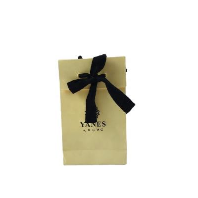 China Recycled Materials China Manufactures Custom Printed Personality Logo Light Yellow Luxury Paper Gift Bag With Bowknot For Small Commodities Packaging for sale