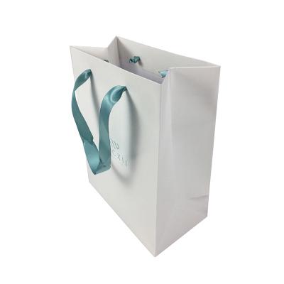 China Newest Design Eco-Friendly Luxury Glossy Shiny Boutique Paper Gift Packaging UV UV Shopping Bag With Ribbon Handle for sale