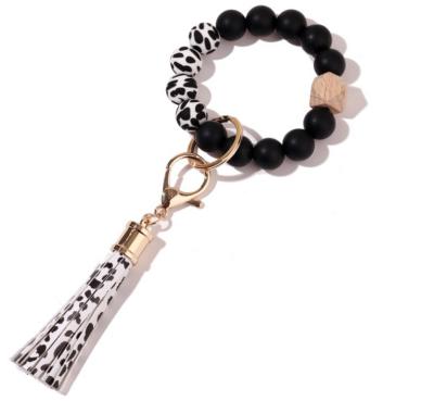 China Key Chain New Customize Silicone Bracelet Leopard Bead Tassel Bracelet Key Chain for sale