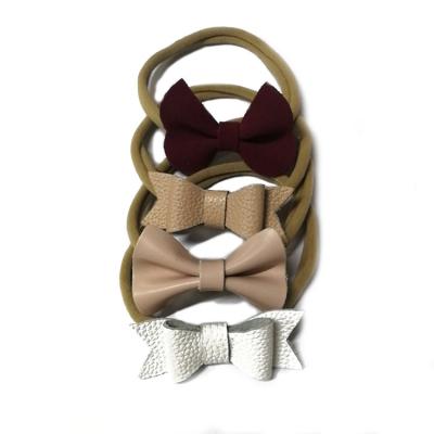 China Cute Hot Selling Kids Baby Hair Band Solid Color Baby Bow Genuine Leather Headband For Girls for sale