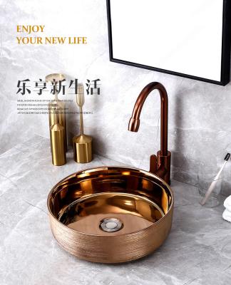 China Contemporary Rose Gold Plated Ceramic Features Creative Brushed European Style Countertop Scratch Wash Basin Art Wash Basin for sale