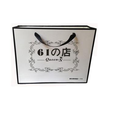 China Recyclable Japanese luxury boutique brand retail custom clothing shopping paper bag with customized logo for sale