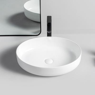 China Durable Single Vessel Sundowner Oval Table Top Wash Basin Designs Villa Bathroom Countertops Pure White Ceramic Sink for sale