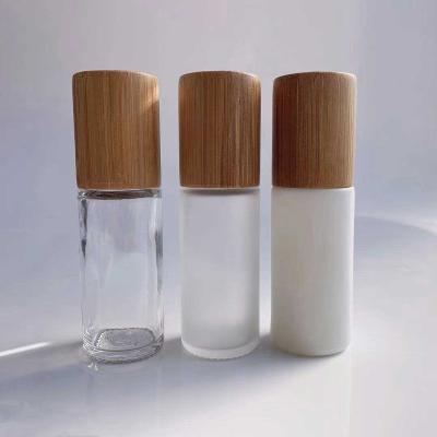 China 30ML 50ML Cosmetic Clear White Frosted Glass Air Freshener Roll On Bottle With Bamboo Lid for sale