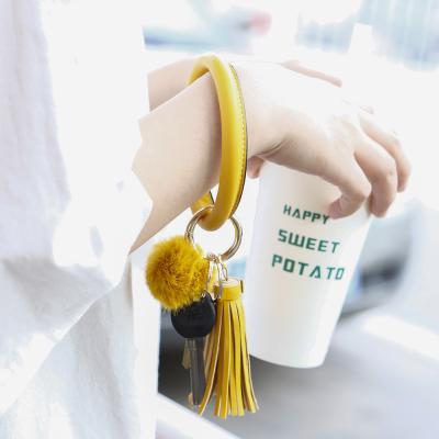 China Key Chain Bracelet Ring Leather Pom Pom Circle Tassel Holder Festival Decoration Amazon Key Bracelet For Women Gift Free Your Hands for sale