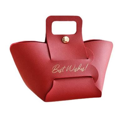 China Viable in New Faux Leather Handbag Stock Design Wedding Candy Portable Gift Boxes with Knot Bow for sale