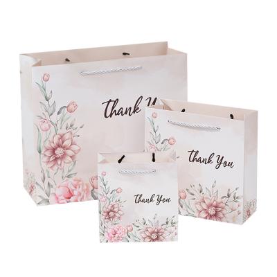 China Luxury Recyclable White Shopping Perfume Clothing Cosmetic Bag Gift Wrapping Paper Handle Logo Printed Paper Bag Custom For Clothes for sale