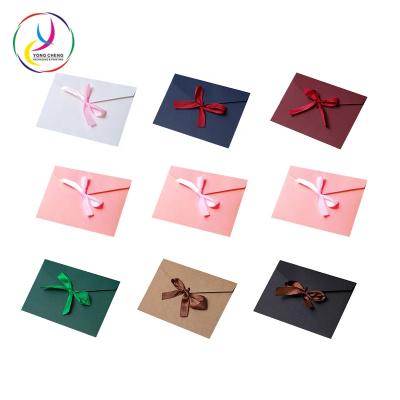 China Recyclable Stocked 250gsm Bow Tied Envelope Paper Packaging For Wedding Invitation for sale