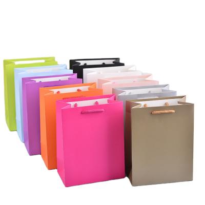 China Recyclable Custom Printed Luxury Kraft Paper Shopping Bags Stock Paper Gift Paper Bag for sale