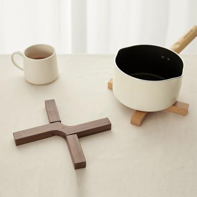 China New viable creative x-shaped detachable shrinkable wooden pot holder of place mat for sale