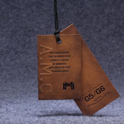 China Sustainable Custom Printing Brown Kraft Paper Embossed Paper Hang Tags For Clothing for sale