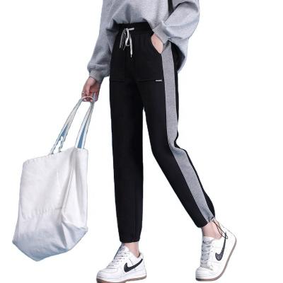 China Anti-wrinkle 2022 autumn and winter new large pocket women's elastic loose drawstring solid color harem pants large size pants for sale