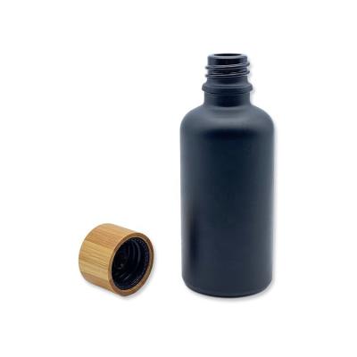 China Bamboo Cosmetics 5ml 10ml 15ml 20ml 30ml 50ml 100ml Cap Black Frosted Lotion Glass Bottle For Skin Care Packaging for sale