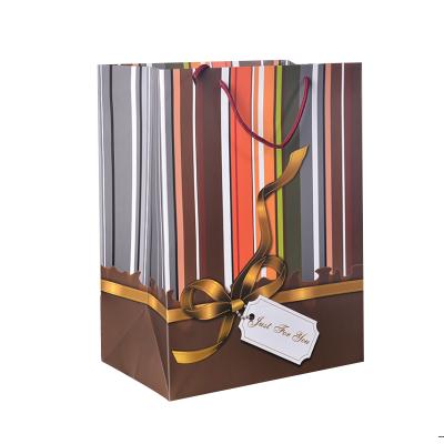 China Recycled Materials Striped Ivory Board Paper Bag Luxury New Hand Held Gift Bag Packaging With Rope Ribbon for sale