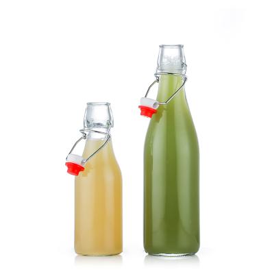 China Beverage Clear 272ml 537ml 995ml Juice Beer Drinking Glass Mineral Water Bottles Swing Top With Caps for sale