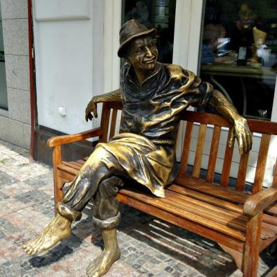 China Custom Life Size Outdoor Modern Garden Bronze Man Sculpture Sitting On Bench For Sale for sale