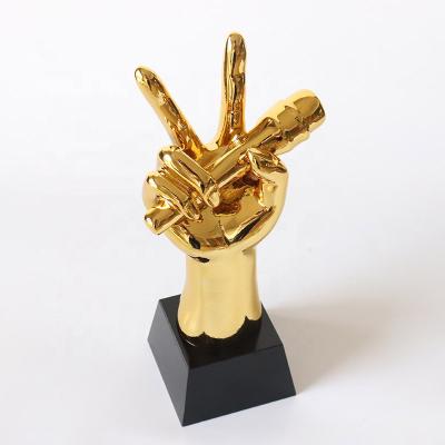 China Health Care Institute Custom Gold Color Resin Voice Hand Trophy With Crystal Base for sale