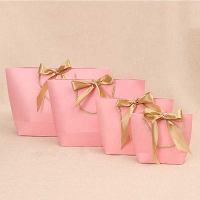 China Holiday Season Party Biodegradable Christmas Gift Bags Women Clothing Kraft Brown Gift Paper Bags Custom Logo for sale