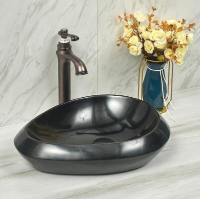 China Modern Unique Shape Bathroom Cabinet Black Natural Stone Sink for sale