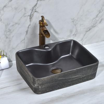 China Chinese high quality hand carved black color rectangular shape bathroom porcelain sink with faucet hole for sale