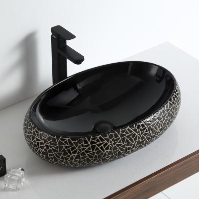 China Modern Luxury Oval Ceramic Bathroom Countertop Delicate Black Look Wash Basin India for sale