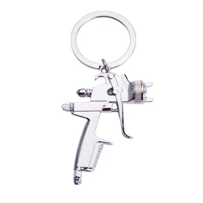 China Creative custom mini size gun shape key chain metal car keychains water gun key chain for sale