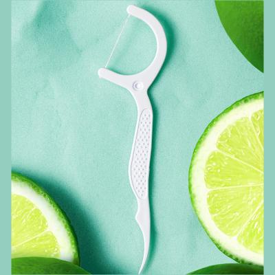 China For Home Use Top sales 100pcs waxed mint flavored tooth pick Lime floss sticks toothpick with floss flosser picks for sale