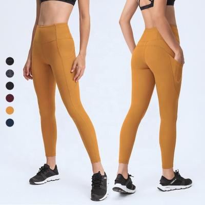 China Solid Color Breathable Wholesale High Waist Yoga Wear Fitness Yoga Pants Gaiters For Women With Side Pockets for sale