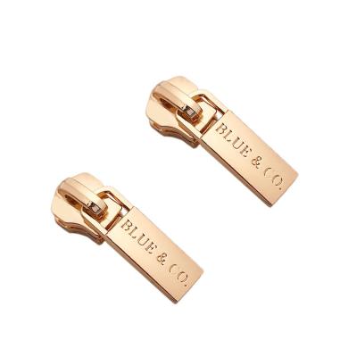 China Custom brand logo rose gold designer metal zipper nickel free embossed zinc alloy puller with slider for bag for sale