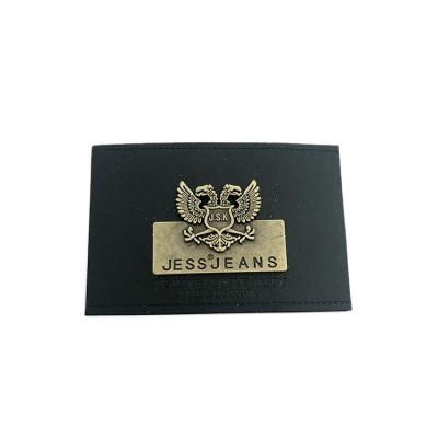 China Durable washable embossed brand black logo custom faux PU leather label faux patches with metal plate for jeans for sale