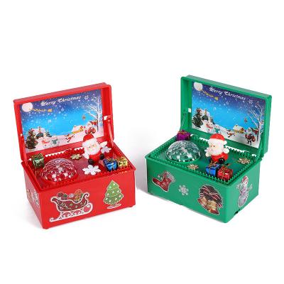 China Amazon plastic wholesale hotsale listing promotion music box Christmas automatic raise-lower lighted music box for sale