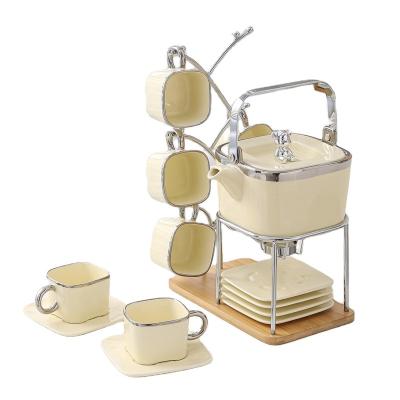 China Viable Luxury Set of 6 Pcs Glossy Beige Ceramic Mug Tea Pot and Holder Tea Coffee Set with Silver Trim Decor Gift Box Package for sale