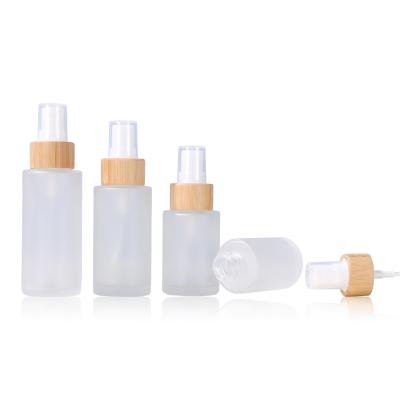 China 20ml 30ml 40ml 50ml 60ml 80ml 100ml stock empty clear cosmetic frosted flat shoulder spray pump glass bottle with bamboo lid for sale