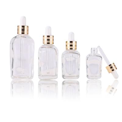 China 10ml 20ml 30ml 50ml 100ml Cosmetic Wholesale Luxury Transparent Irregular Square Dropper Empty Essential Oil Glass Bottle Customizable for sale