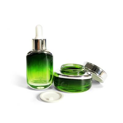 China Hot Sale Cosmetic Manufacturers Cosmetic Package 30ml 30g Empty Green Glass Dropper Essential Oil Bottle Cream Jar Set Customizable for sale